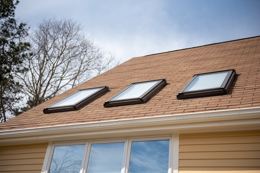 Triple,Skylights,On,Red,Roof,With,Yellow,Siding,And,Blue